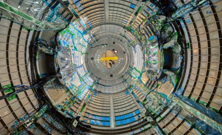 As we look through a circular piece of Gateway, a space station that will be in lunar orbit, there are blue wires snaking through. The wires are covered in clear plastic in some places and held onto the walls by green tape in others.