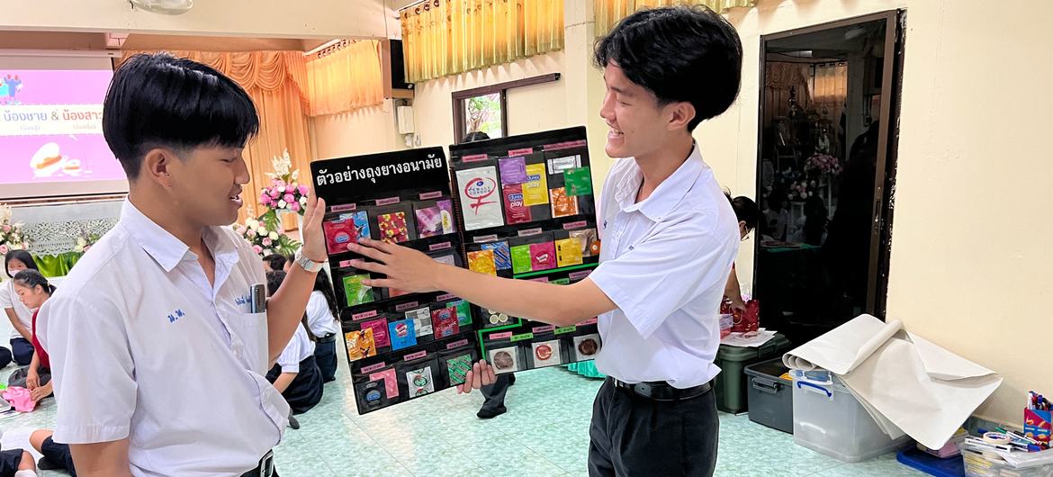 Two Thai peer educator high school students describe a range of available condoms.