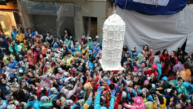 A giant, human-sized dessert gets dropped into the crowd