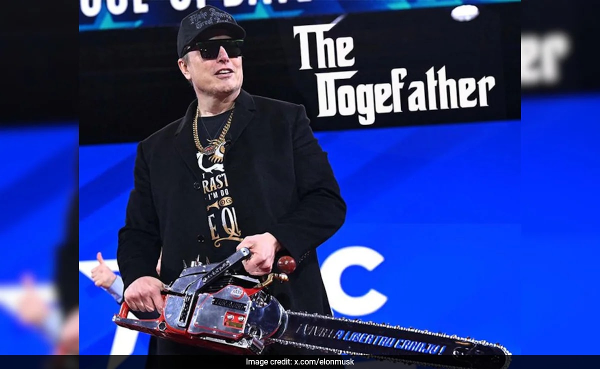 Elon Musk Waves 'Chainsaw' On Stage Celebrating Trump's Cost-Cutting Efforts