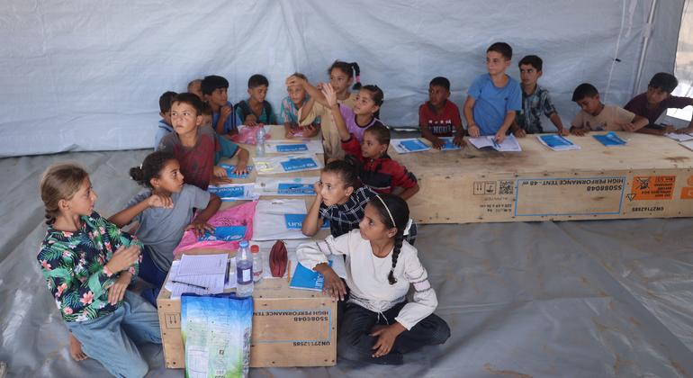 Children in Gaza study on desks made from wooden pallets.