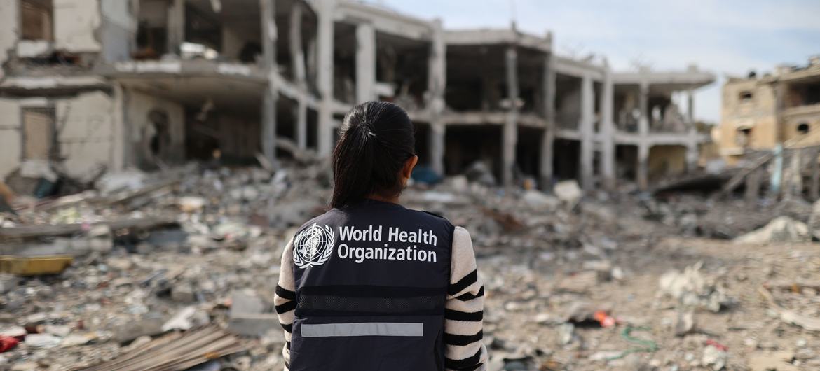 A WHO worker assesses a destroyed hospital in northern Gaza. A WHO worker assesses a destroyed hospital in northern Gaza.