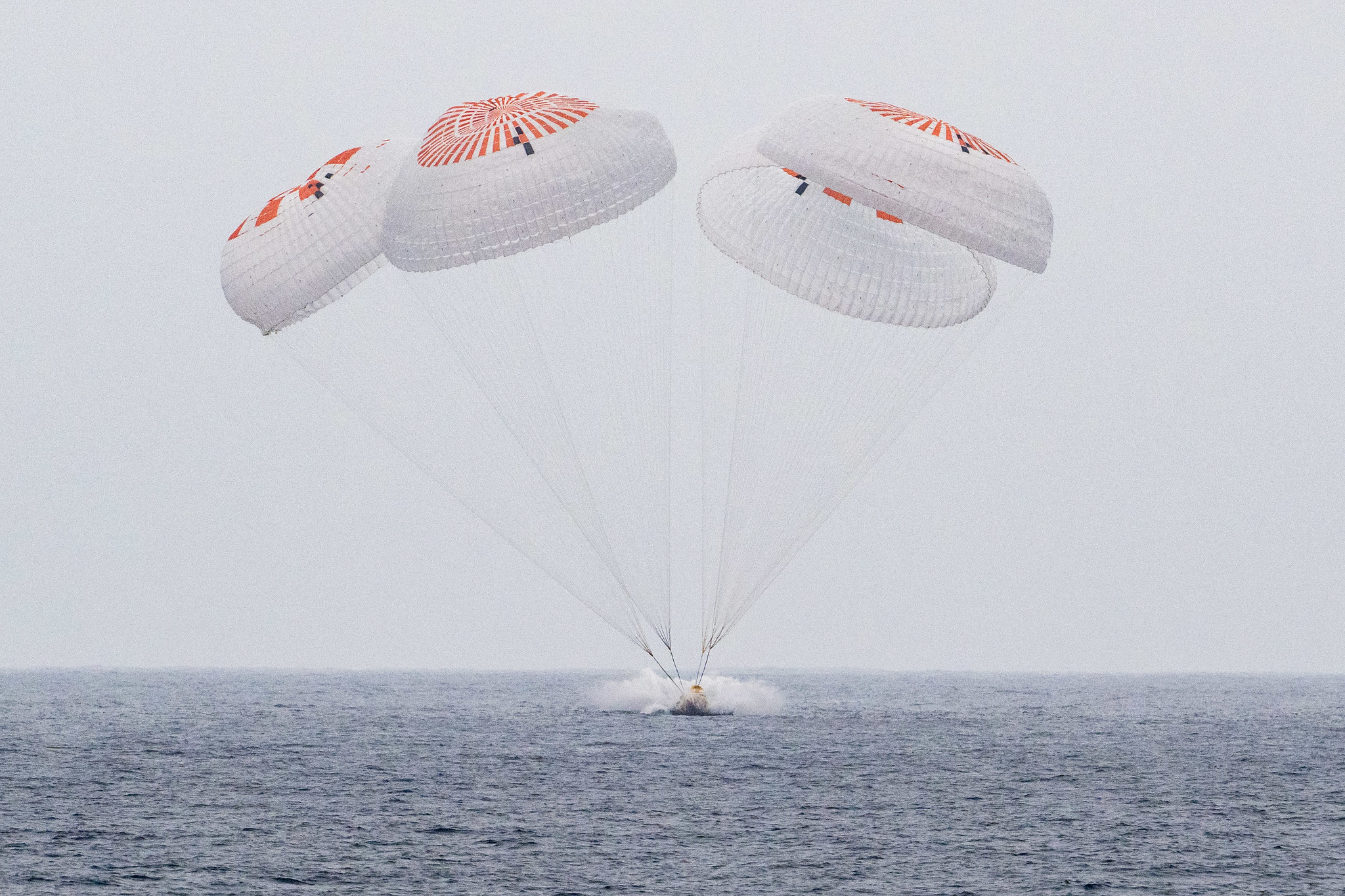 The SpaceX Crew Dragon Endurance spacecraft is seen as it lands with NASA astronauts Anne McClain and Nichole Ayers, JAXA (Japan Aerospace Exploration Agency) astronaut Takuya Onishi, and Roscosmos cosmonaut Kirill Peskov aboard in the Pacific Ocean off the coast of San Diego, Calif., Saturday, Aug. 9, 2025. McClain, Ayers, Onishi, and Peskov are returning after seven-months in space as part of Expedition 73 aboard the International Space Station.