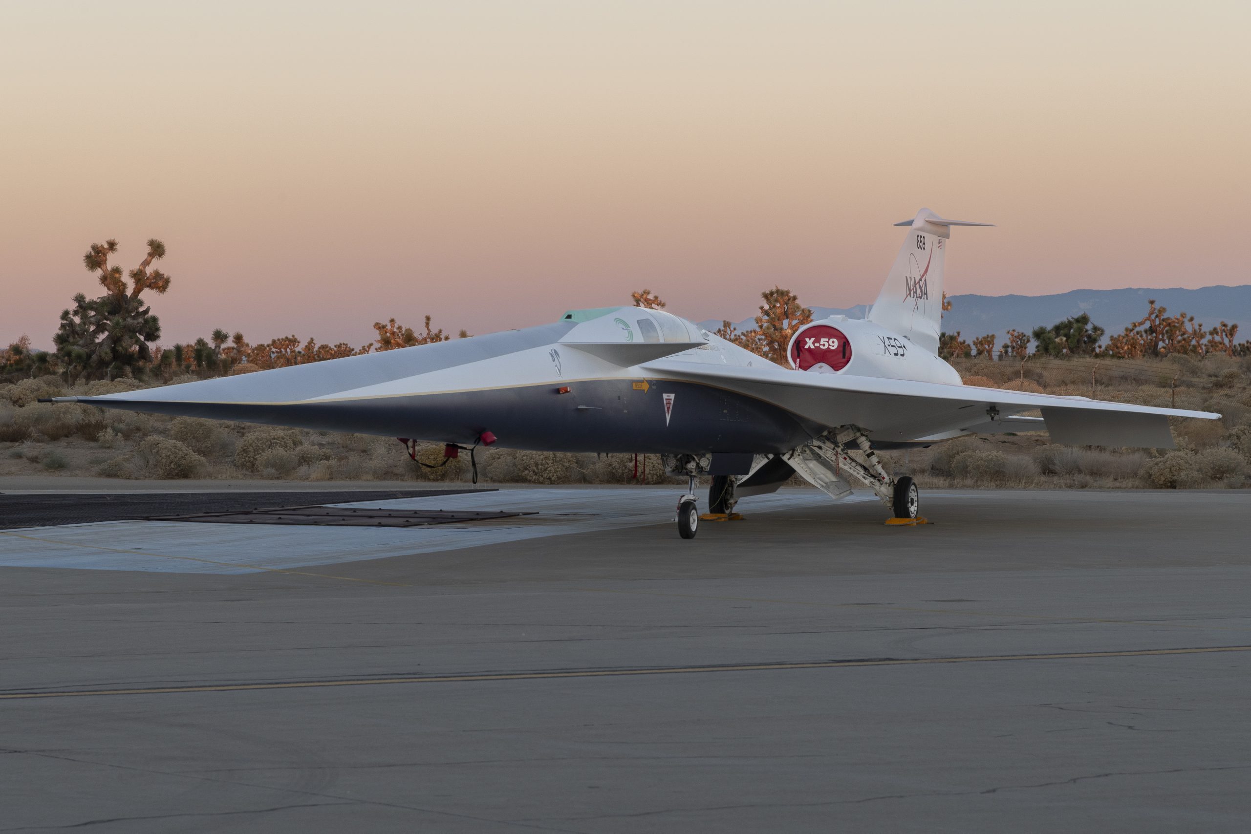 NASA’s X-59 quiet supersonic research aircraft sits on the ramp at Lockheed Martin Skunk Works in Palmdale, California during sunrise, shortly after completion of painting in December 2023.