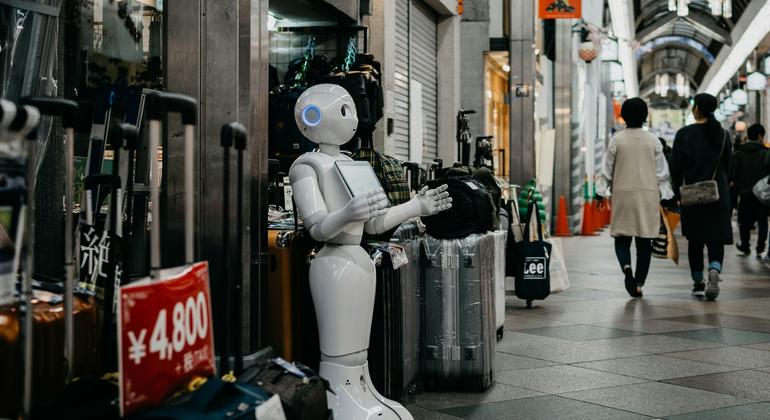A robot which could carry out tasks assigned to humans stands in a shopping mall in Kyoto, Japan. A robot which could carry out tasks assigned to humans stands in a shopping mall in Kyoto, Japan.