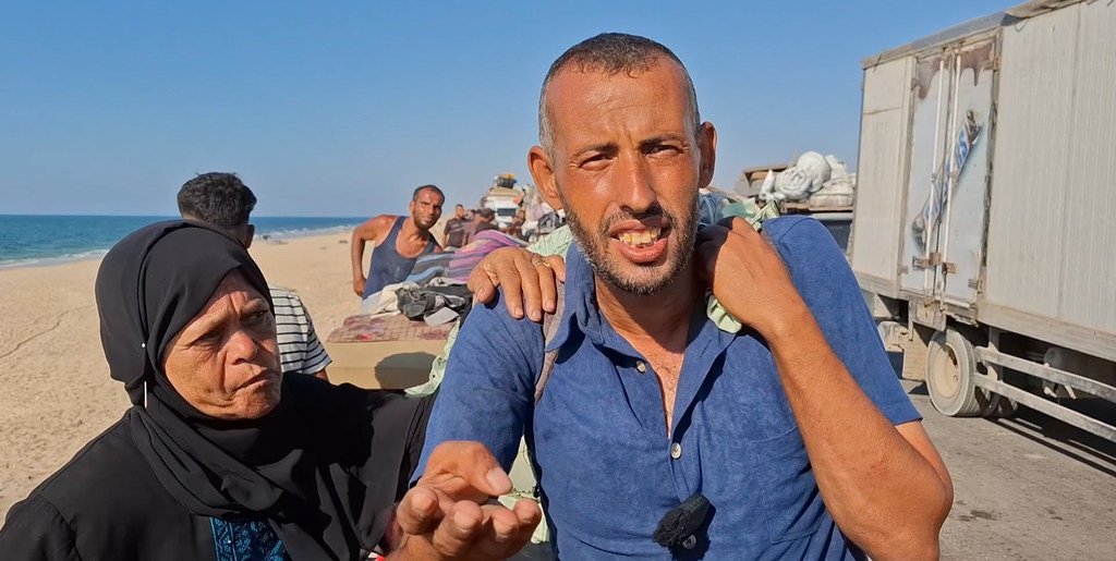 From Gaza, Ayman al-Khatib during his displacement journey on foot with his aunt. From Gaza, Ayman al-Khatib during his displacement journey on foot with his aunt.