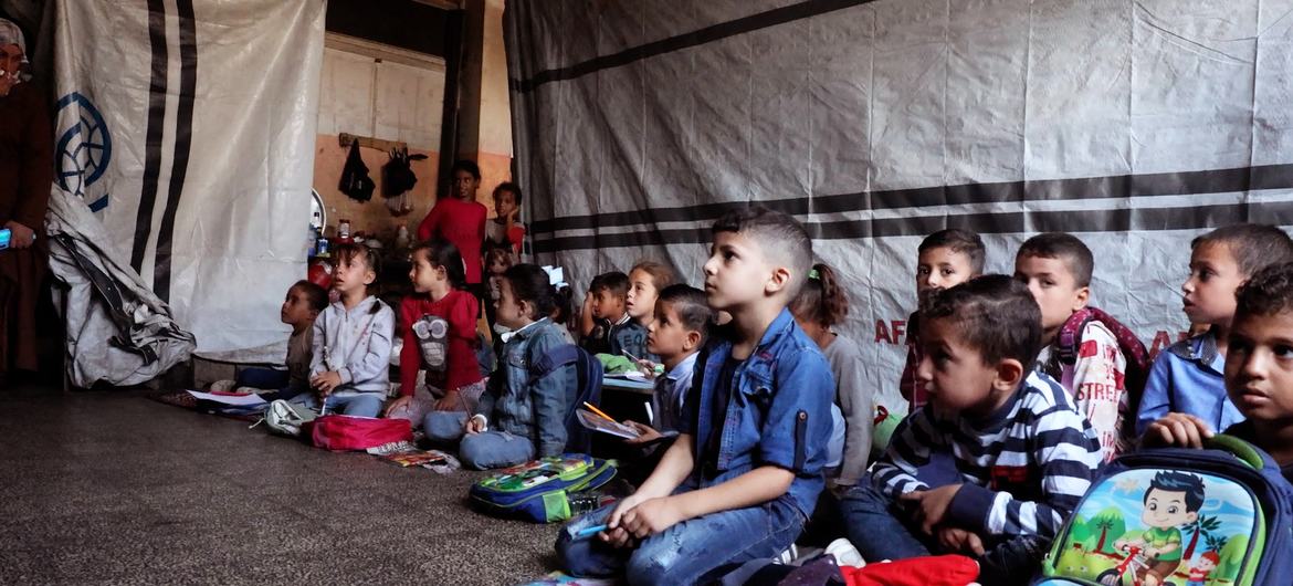 Students sitting on the floor while attending classes at Deir al-Balah Co-educational Primary School, run by UNRWA. Students sitting on the floor while attending classes at Deir al-Balah Co-educational Primary School, run by UNRWA.