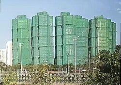 Wang Fuk Court, one day before the fire, encased in bamboo scaffolding and green netting, November 25, 2025 (cropped).jpg