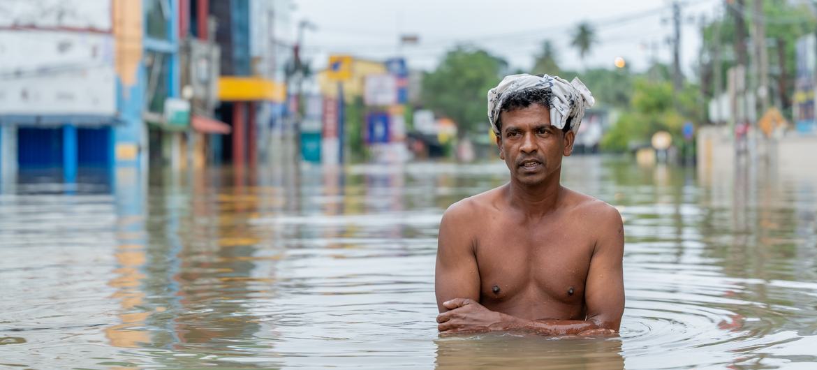 A man stands in over three feet of floodwaters in Gampaha, Sri Lanka.