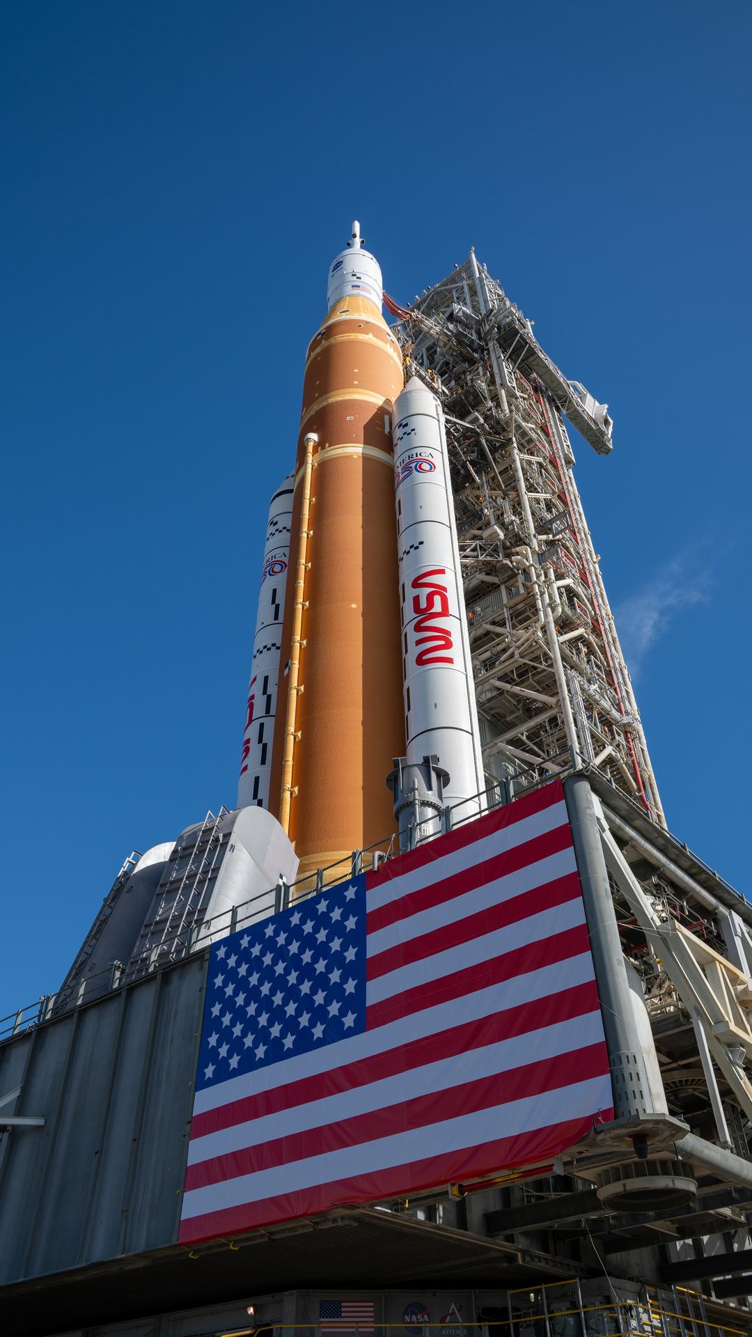 This image shows NASA’s SLS (Space Launch System) and Orion spacecraft rolling out of the Vehicle Assembly Building at NASA’s Kennedy Space Center in Florida