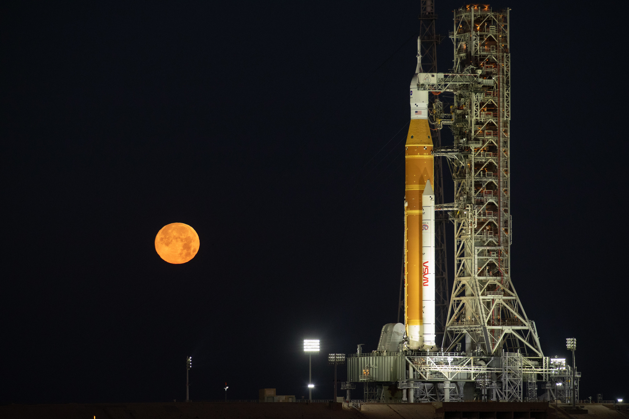 The Moon rises behind NASA’s Artemis II SLS (Space Launch System) rocket and Orion spacecraft atop a mobile launcher at Launch Complex 39B at NASA’s Kennedy Space Center in Florida on Sunday, Feb. 1,. 2026. The Artemis II test flight will take Commander Reid Wiseman, Pilot Victor Glover, and Mission Specialist Christina Koch from NASA, and Mission Specialist Jeremy Hansen from the CSA (Canadian Space Agency), around the Moon and back to Earth.
