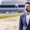 Portrait of Mike Guzman in front of the Launch Control Center at Kennedy Space Center.
