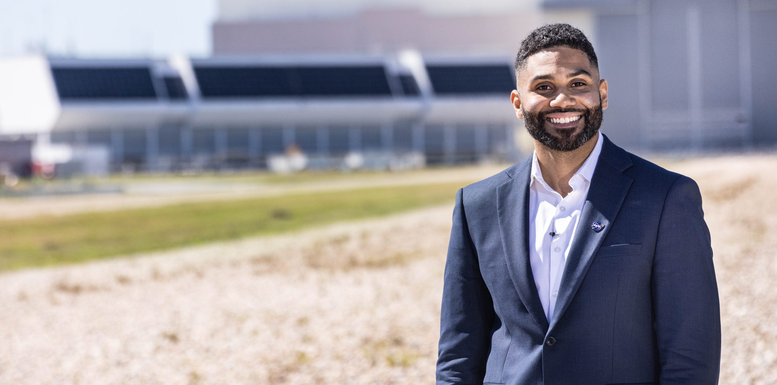 Portrait of Mike Guzman in front of the Launch Control Center at Kennedy Space Center.