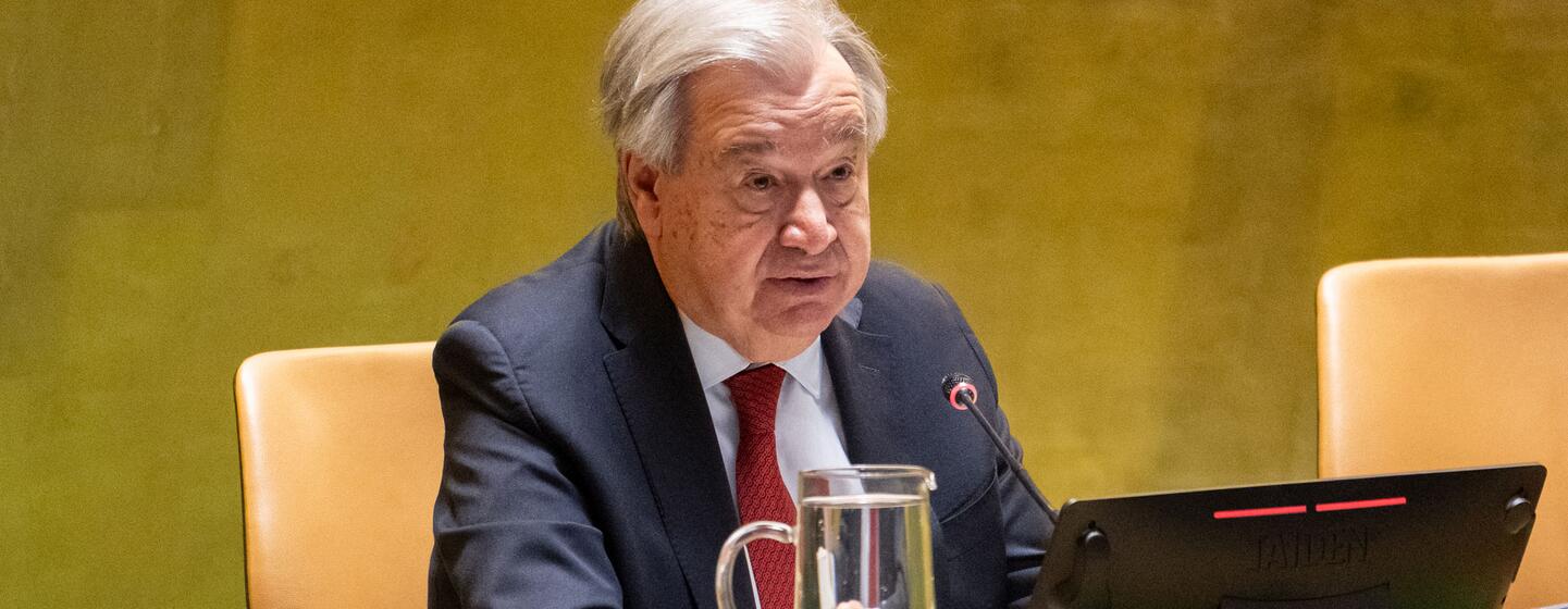 UN Secretary-General António Guterres speaking at a podium during a General Assembly meeting.