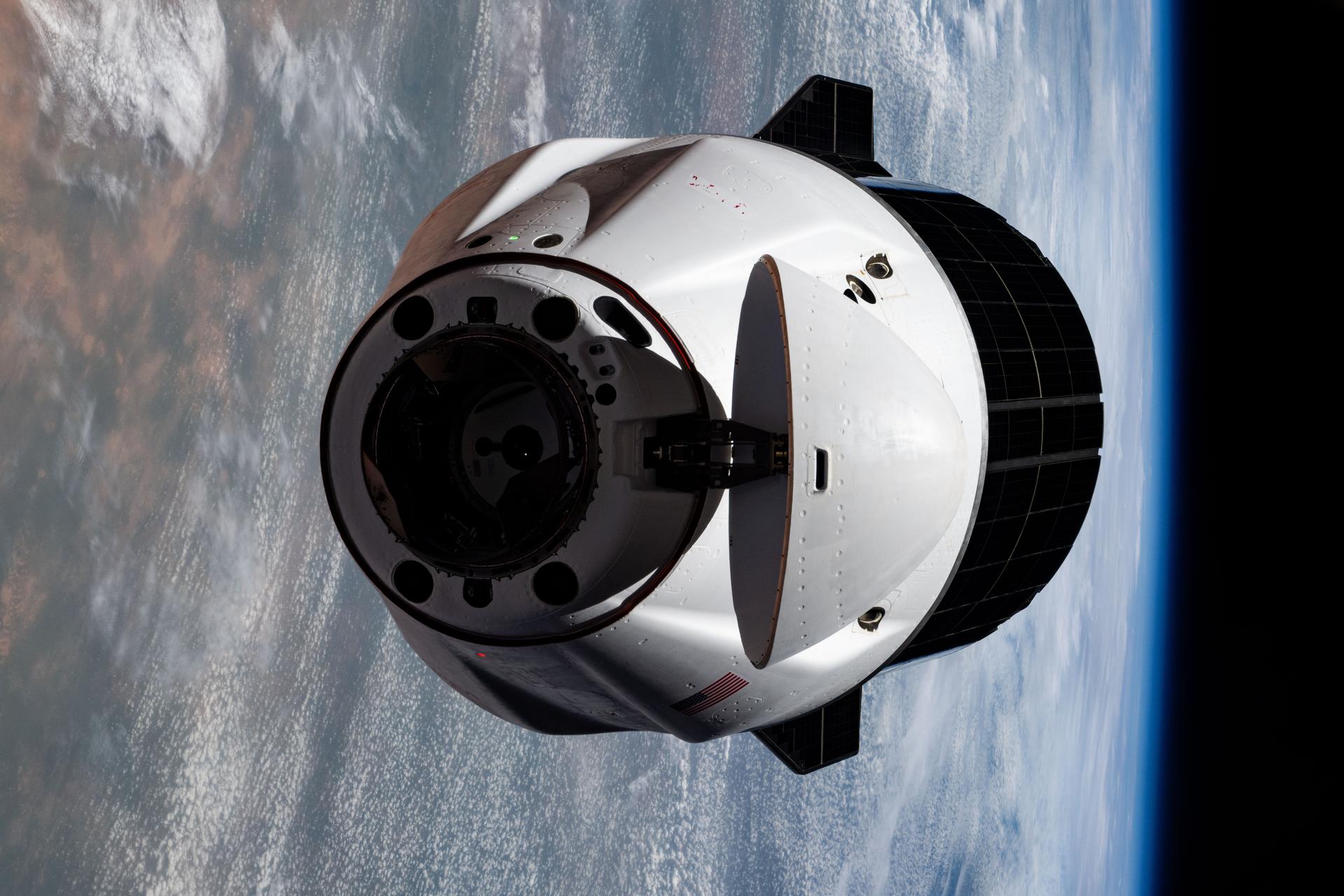 A SpaceX Dragon cargo spacecraft with its nosecone open and carrying over 5,000 pounds of science, supplies, and hardware as NASA's SpaceX CRS-33 mission approaches the International Space Station for an automated docking to the Harmony module's forward port. Both spacecraft were flying 259 miles above western Mauritania near the Atlantic coast at the time of this photograph.