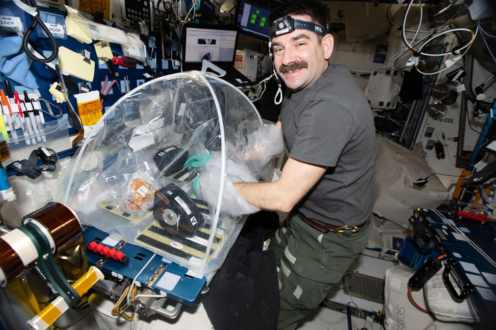 NASA astronaut and Expedition 74 flight engineer Jack Hathaway configures research hardware inside a portable glovebag for a biotechnology investigation exploring how bacteria affect heart tissue in the microgravity environment. Results from the MVP (Multi-use Variable-g Platform) Cell-09 experiment could lead to advanced methods for preventing or treating heart damage in humans living on and off the Earth.